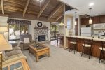 Mammoth Lakes Condo Rental Sunshine Village 136 - Open Area Living Room has a Woodstove and Vaulted Ceilings